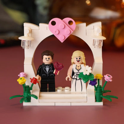 LEGO wedding scene with a couple and heart-shaped arch on a brown background